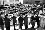 A row of onlookers view the Montereys hauled for maintenance on the skidways at the Jones Street extension of Fisherman's Wharf, circa 1935. Photograph Karl Kortum. Copyright by Jean E. Kortum.