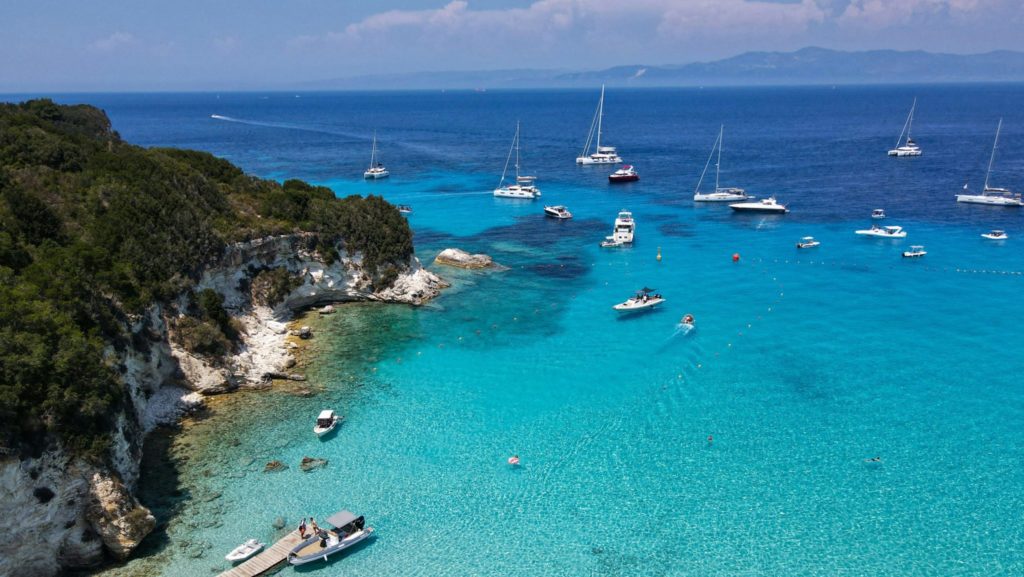 A group of boats floating on top of a body of water