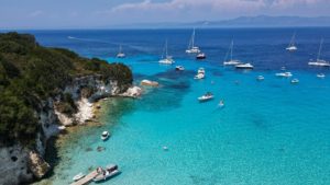 A group of boats floating on top of a body of water
