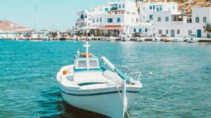 white and blue boat on sea during daytime